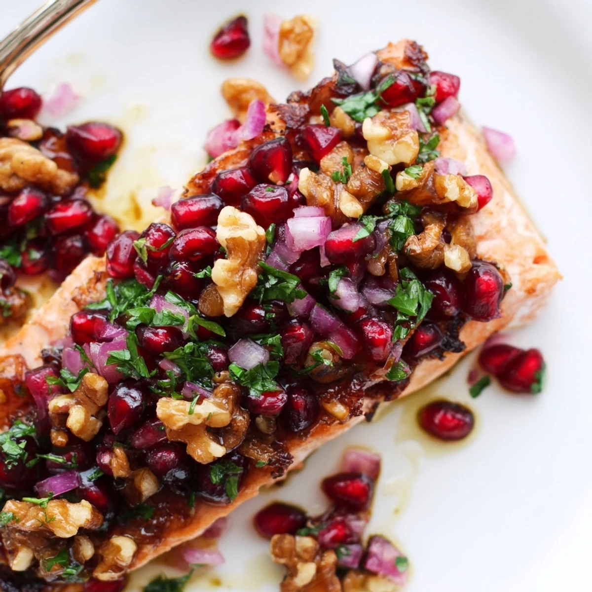 Flaky baked salmon with pomegranate walnut salsa glistens, ready for a delicious dinner.