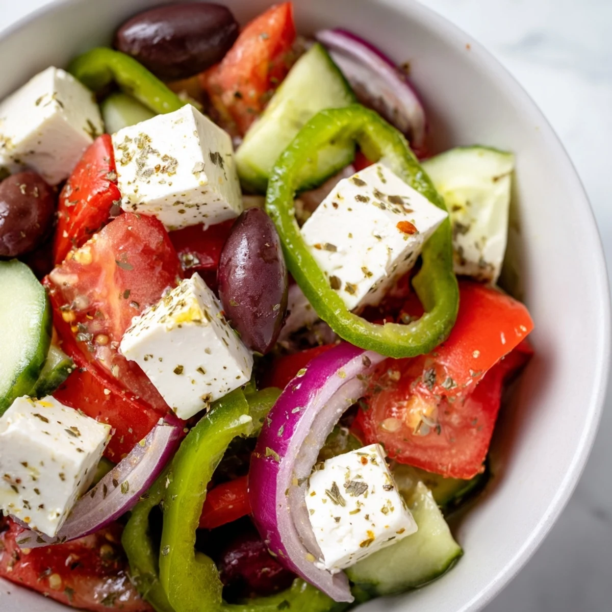 Colorful Greek Salad with Kalamata Olives and Feta served on a plate, ready to enjoy with grilled meats.