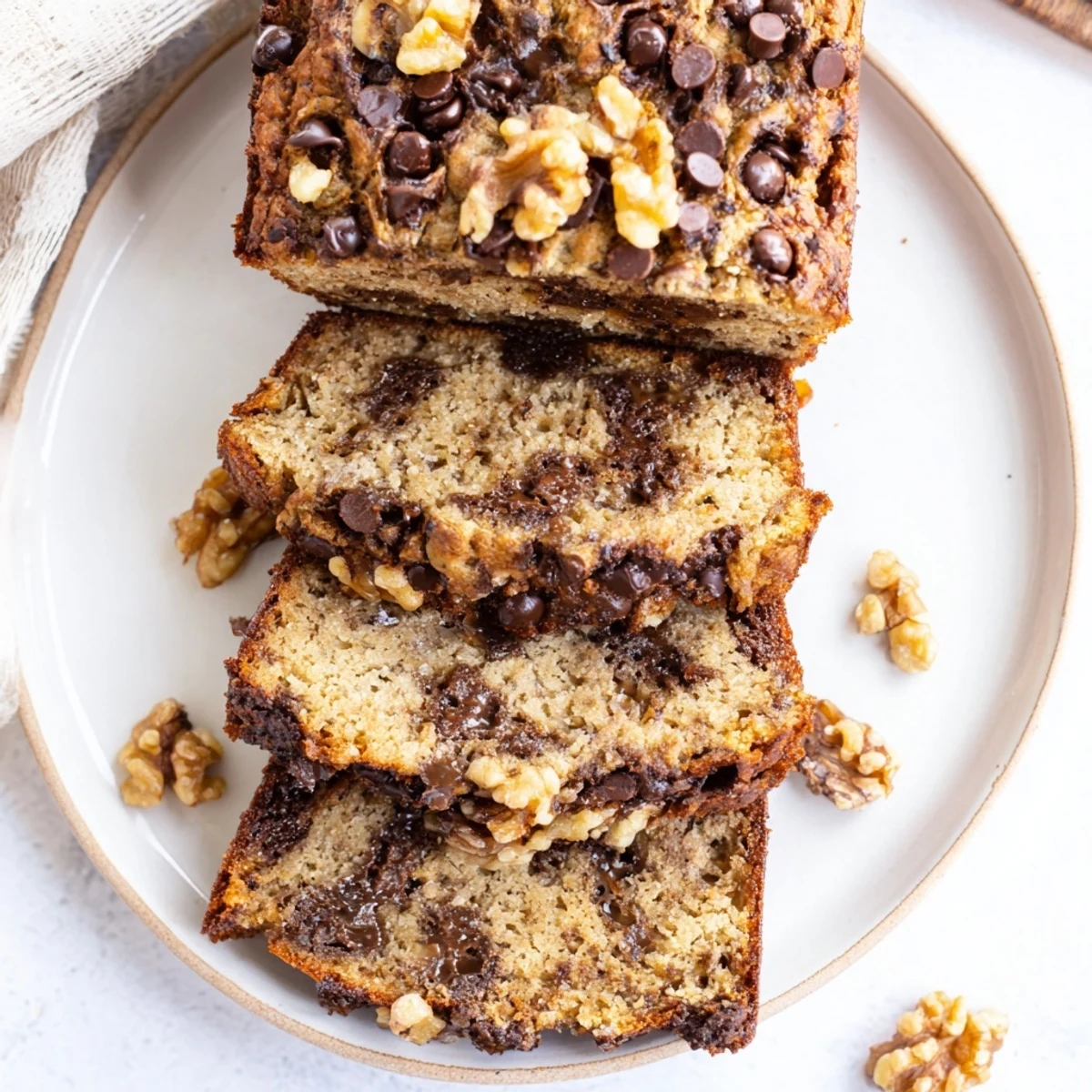 Golden-brown Chocolate Chip Banana Bread with Walnuts cooling on a wire rack, ready to be sliced and enjoyed.