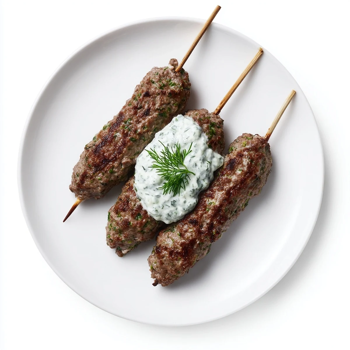 Golden-brown beef kofta kebabs sizzling on the grill, served with a cool, refreshing cucumber yogurt dip.