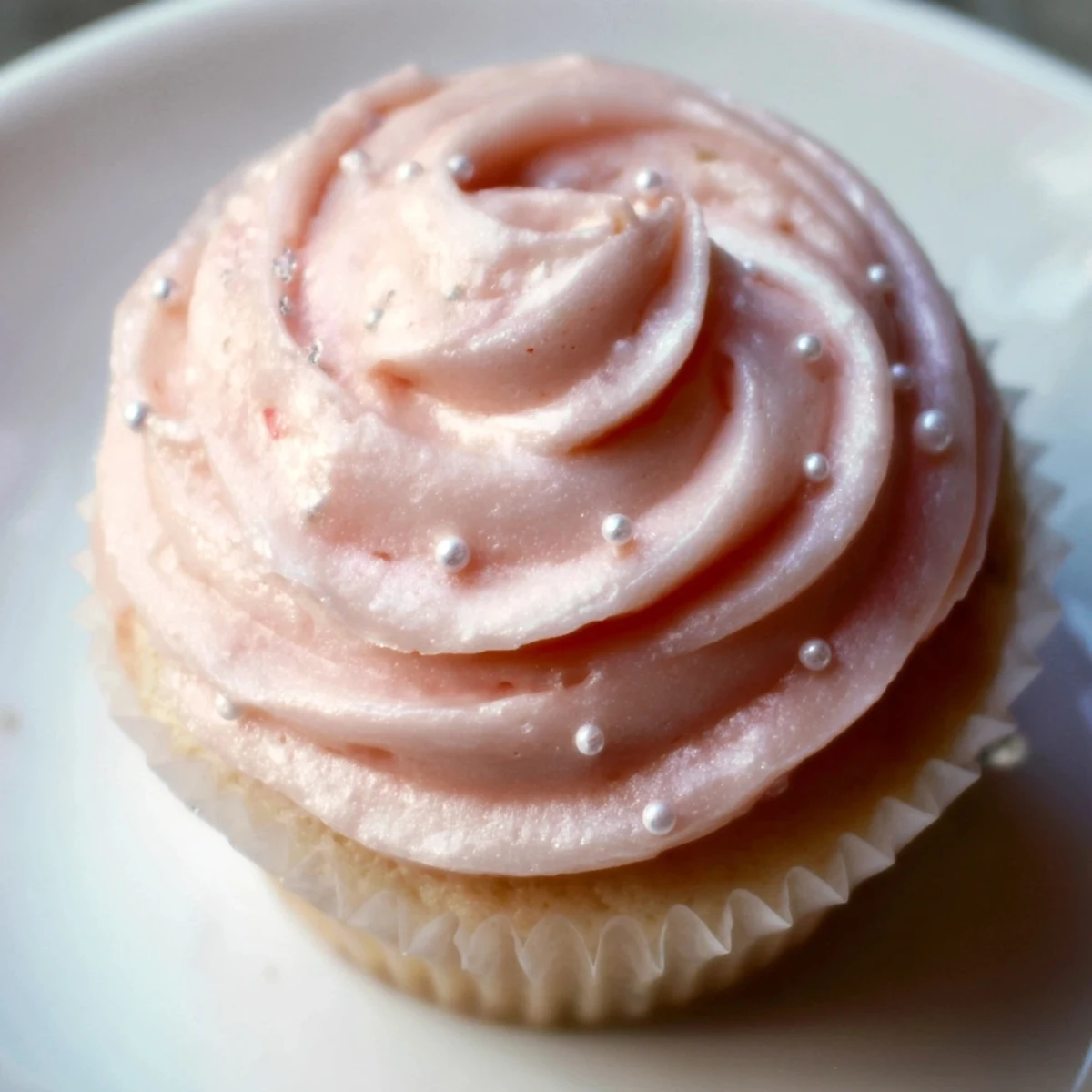 Moist, fluffy Pink Champagne Cupcakes topped with creamy pink buttercream frosting and delicate edible decorations.