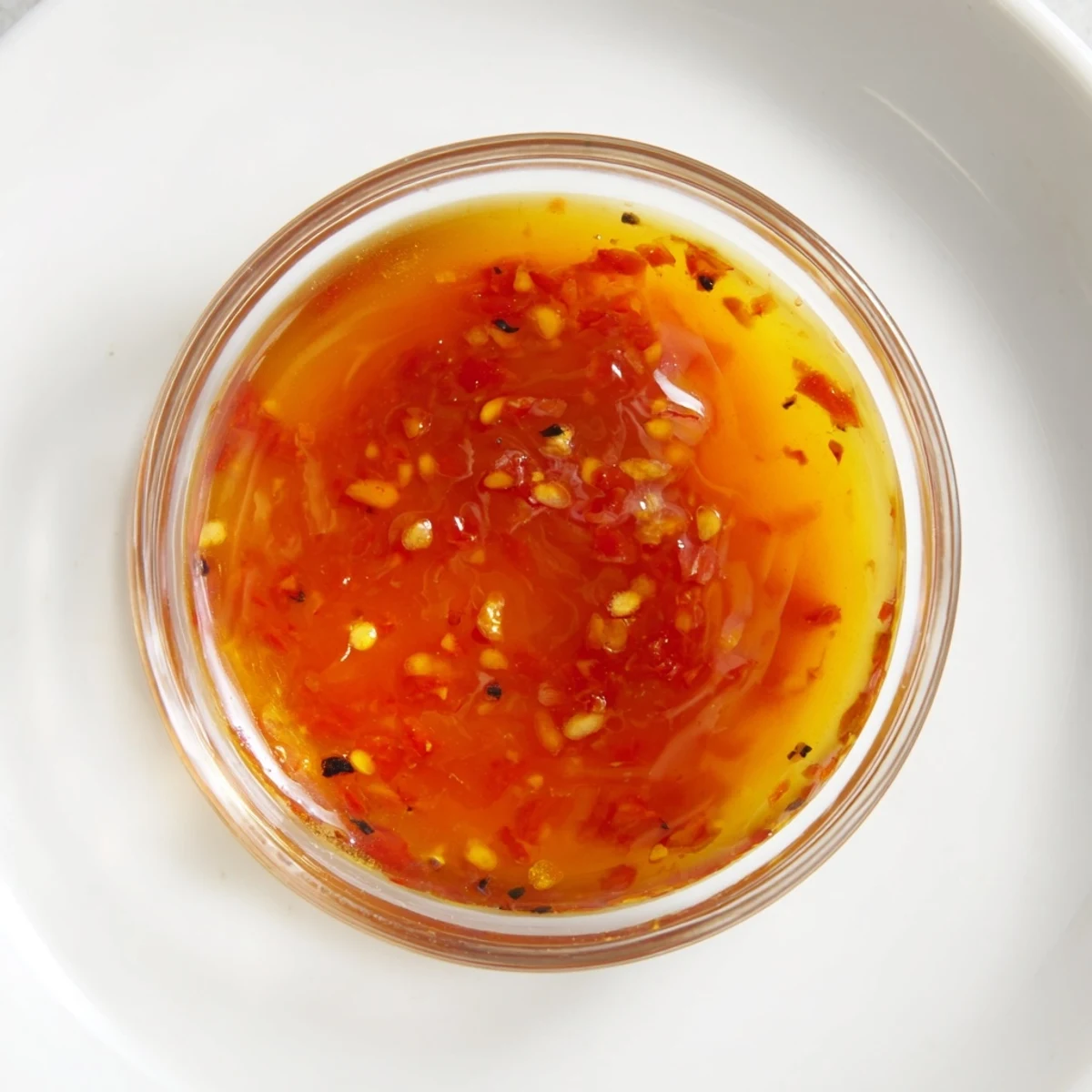 Bright orange carrots and green cabbage coated in glossy Best Asian Coleslaw Dressing, topped with toasted sesame seeds.