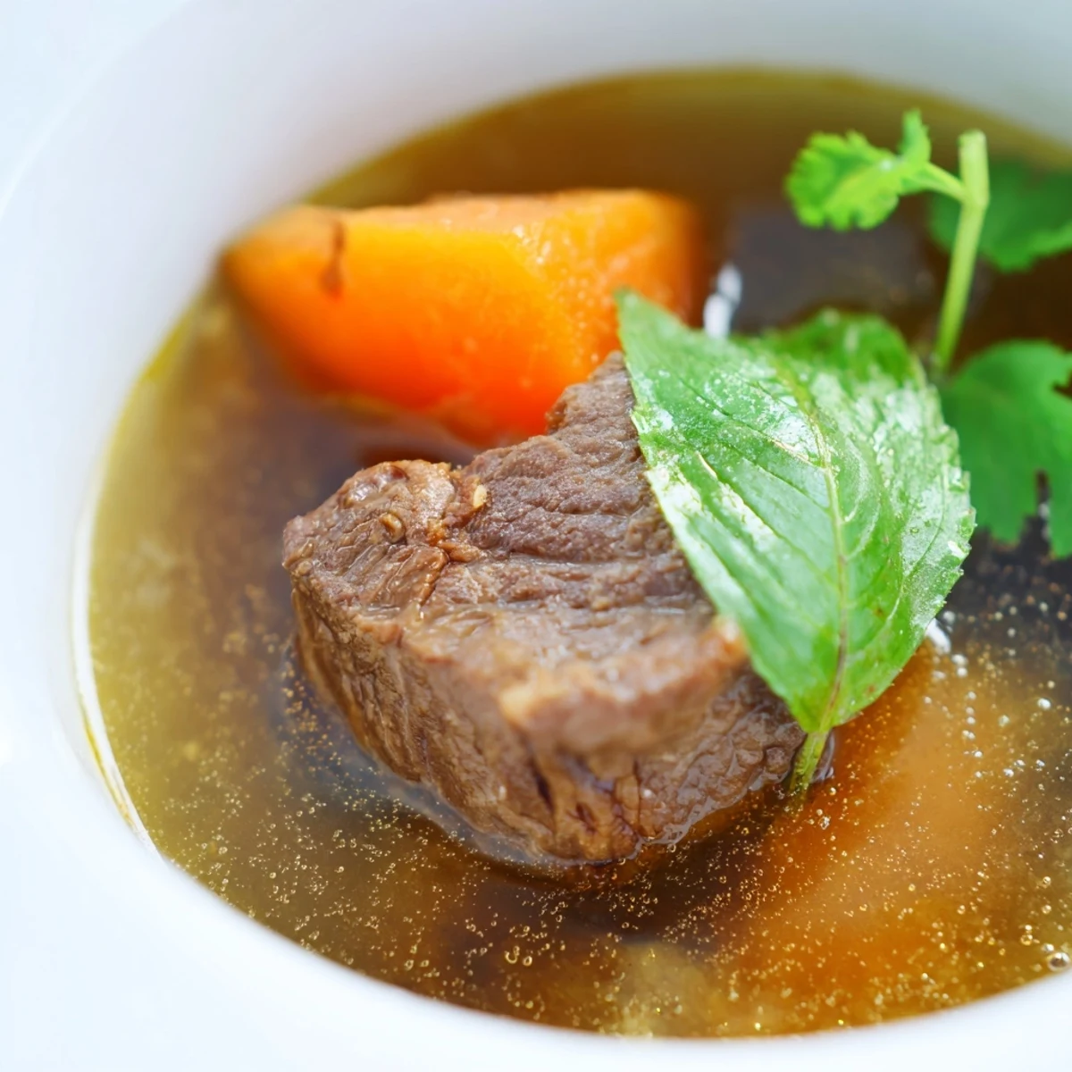 Hearty Vietnamese beef stew with carrots and aromatic spices, simmered until fork-tender and served with crusty bread for dipping. 