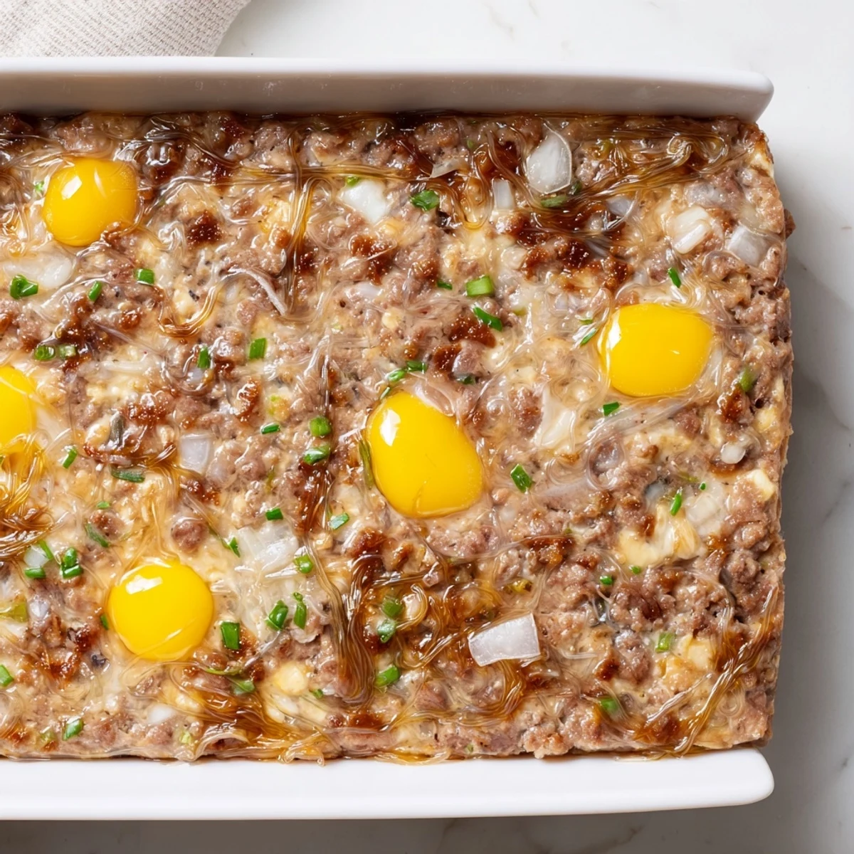 Freshly steamed Cha Trung Hap in a white dish, topped with a glossy golden egg layer, ready to serve.