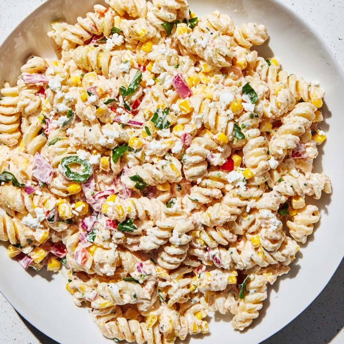 Creamy Mexican street corn pasta salad featuring golden corn, red peppers, and smoky spices