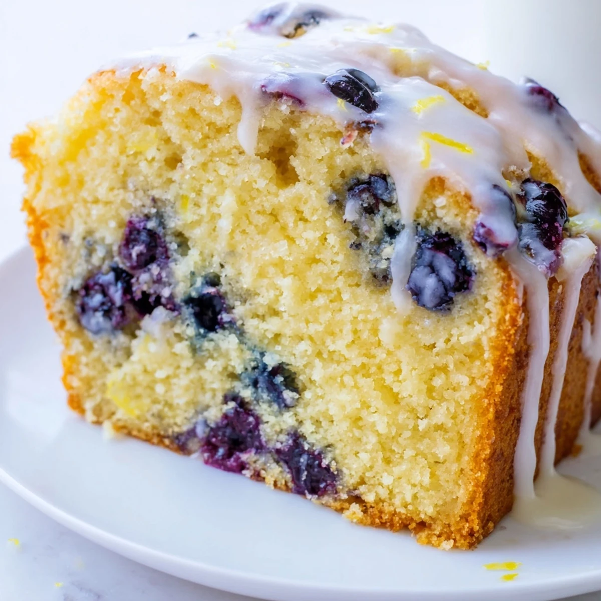 Moist lemon blueberry cake studded with fresh berries and drizzled with sweet lemon glaze