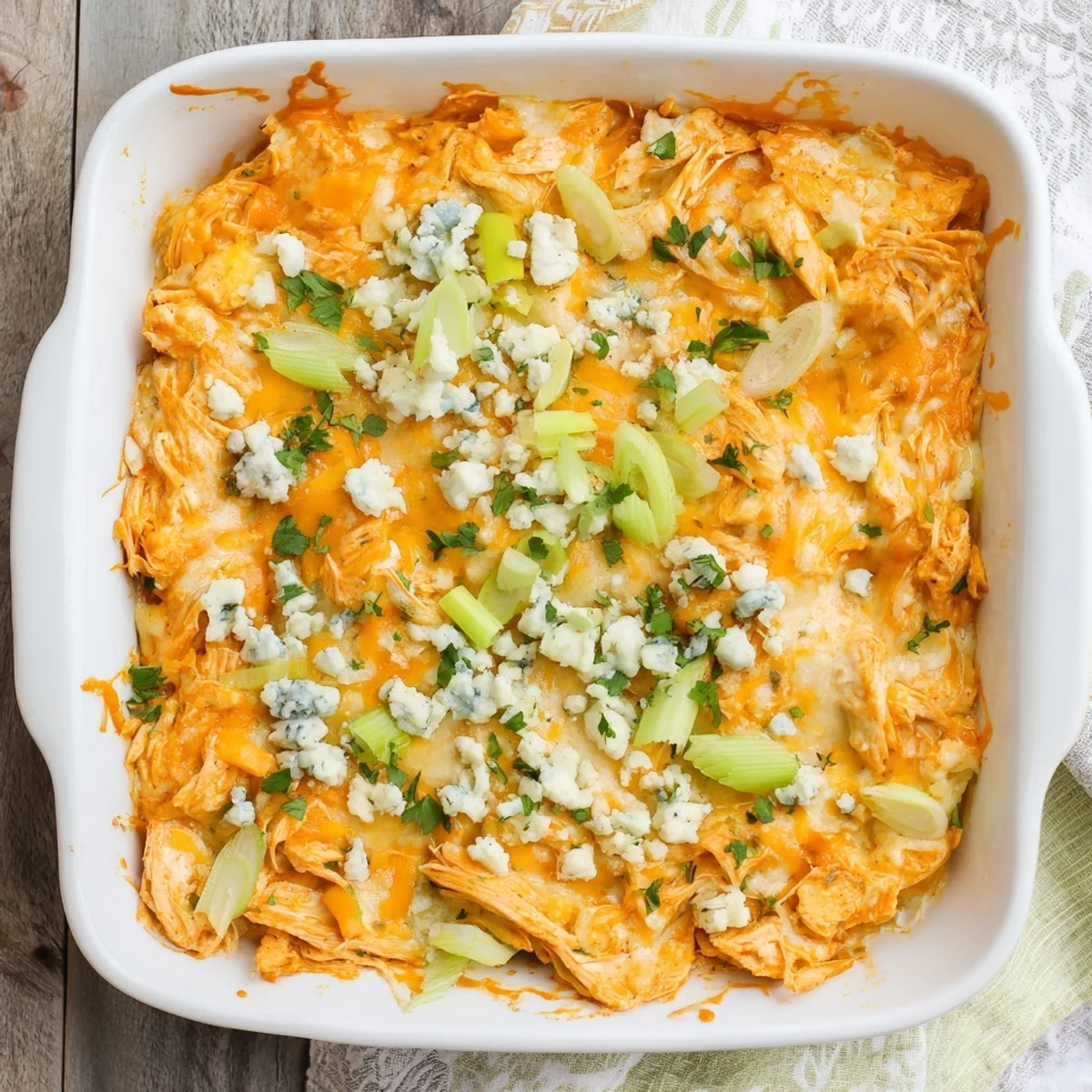 Golden bubbling buffalo chicken cheese bake fresh from the oven with melted cheese topping