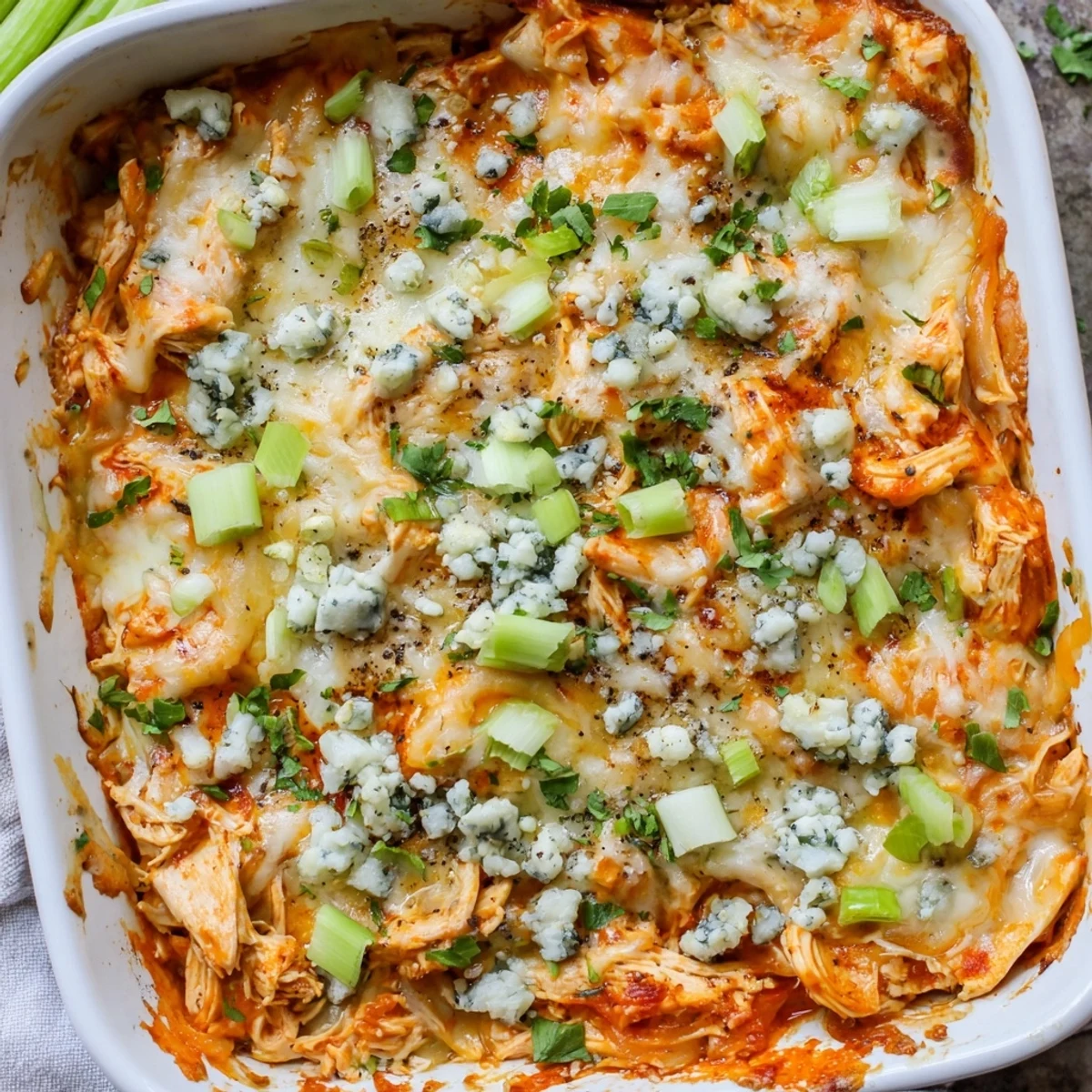 Spicy buffalo chicken cheese bake layered with shredded chicken and creamy melted mozzarella cheddar blend