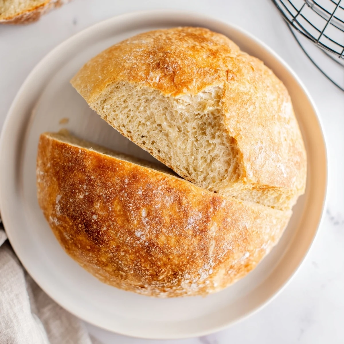 Freshly baked skillet bread sliced open revealing soft white crumbs inside pan