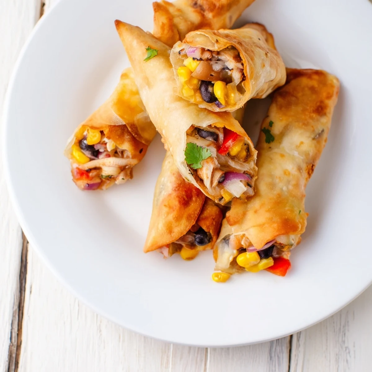 Plate of Southwest egg rolls featuring spicy chicken and vegetable filling ready for dipping