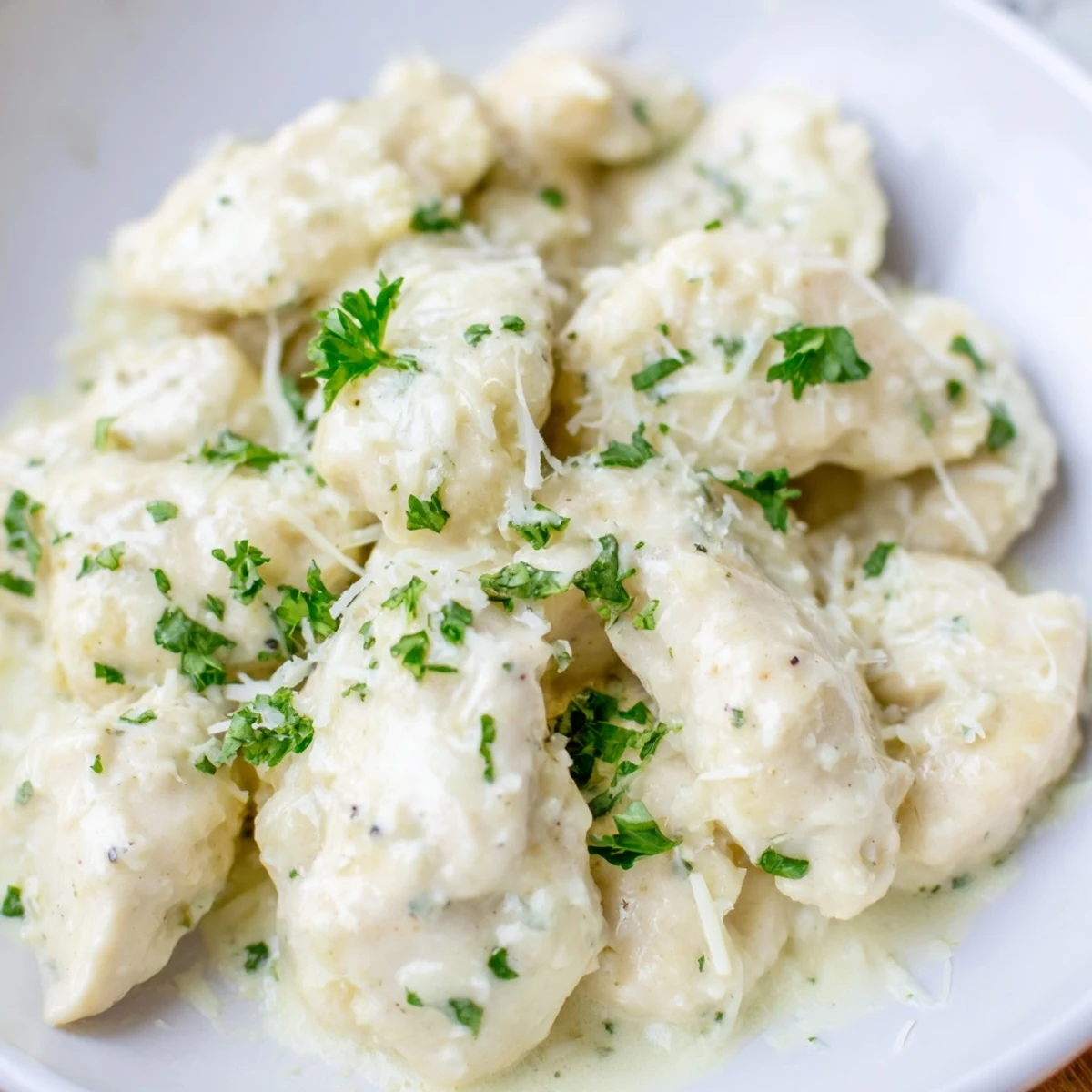 Slow cooker Crockpot Creamy Garlic Parmesan Chicken served over fluffy mashed potatoes for a comforting dinner