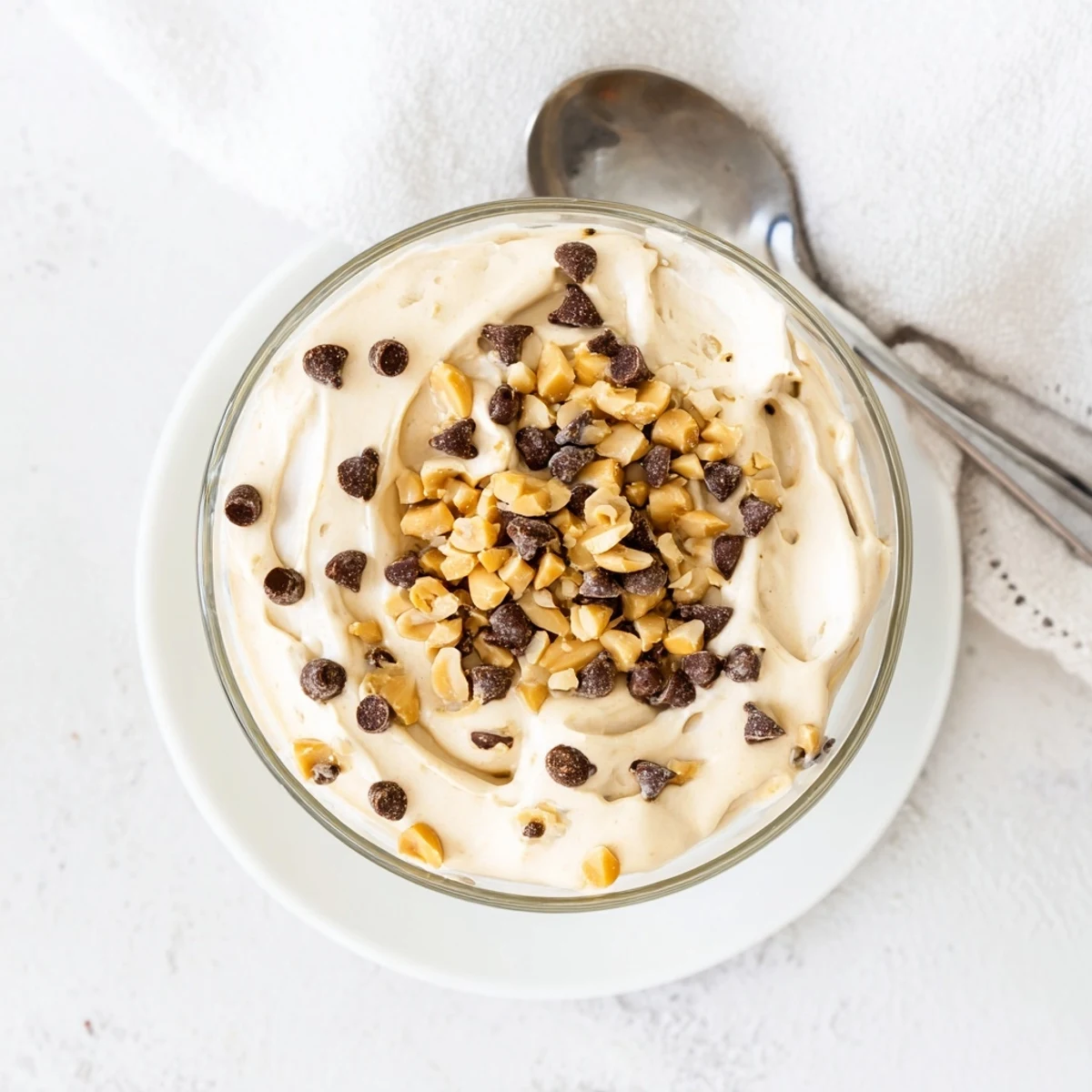 Light no-bake peanut butter and Cool Whip mousse sprinkled with roasted peanuts and mini chocolate chips