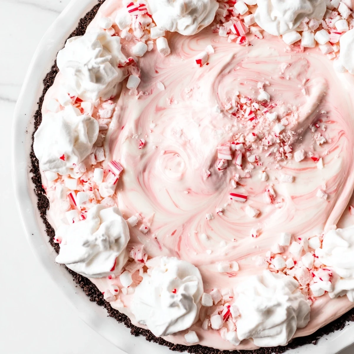 Candy Cane Pie with creamy peppermint filling and chocolate crust, sliced for serving