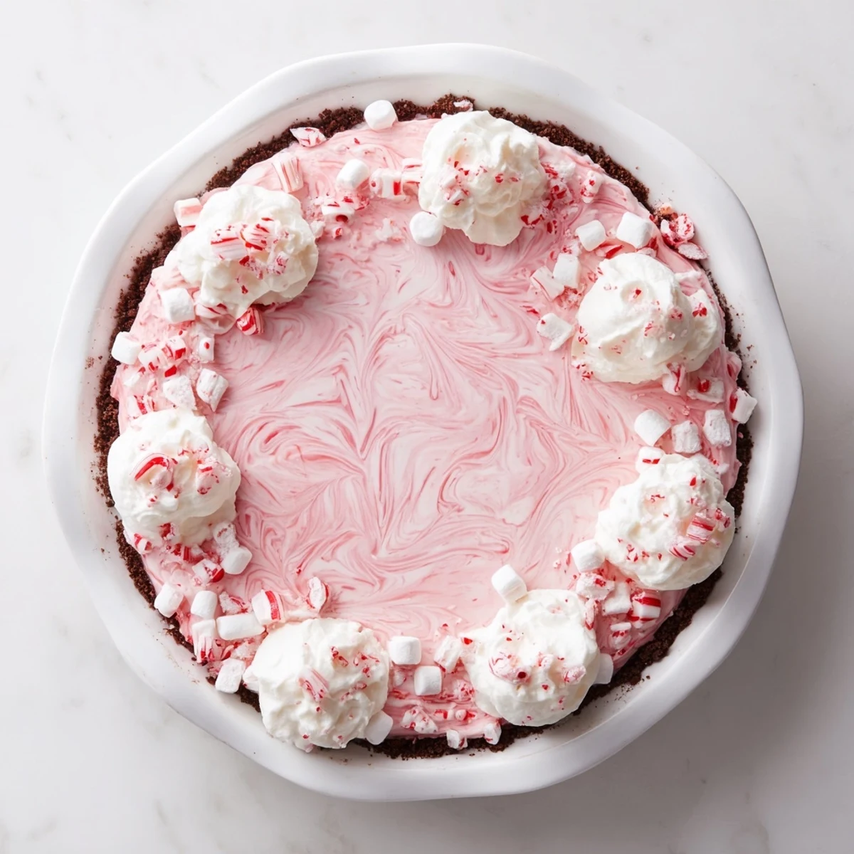 Festive Candy Cane Pie slice showing pink peppermint swirls and crunchy candy cane bits