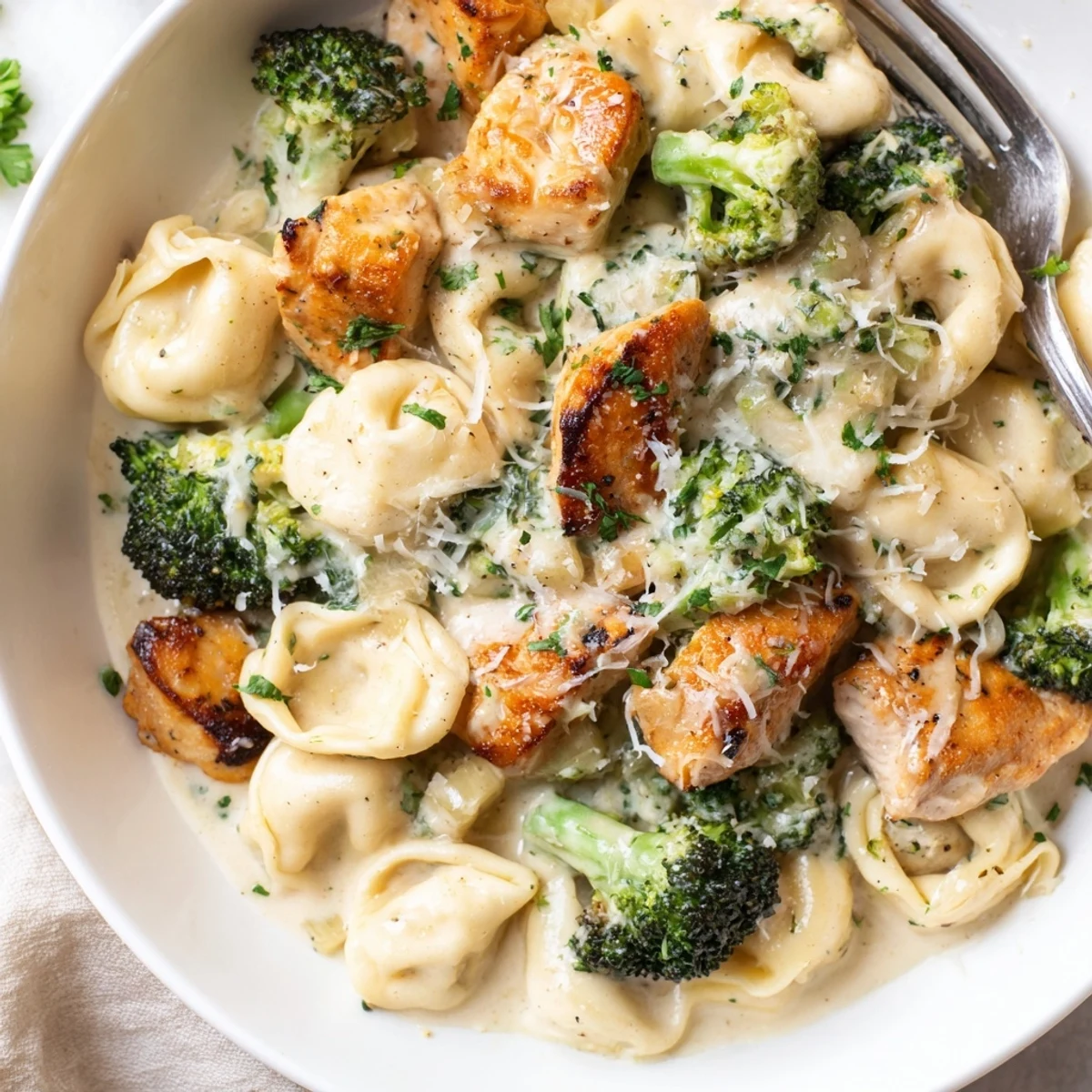 Warm Creamy Garlic Parmesan Tortellini Chicken Broccoli Recipe, juicy chicken and crisp broccoli.