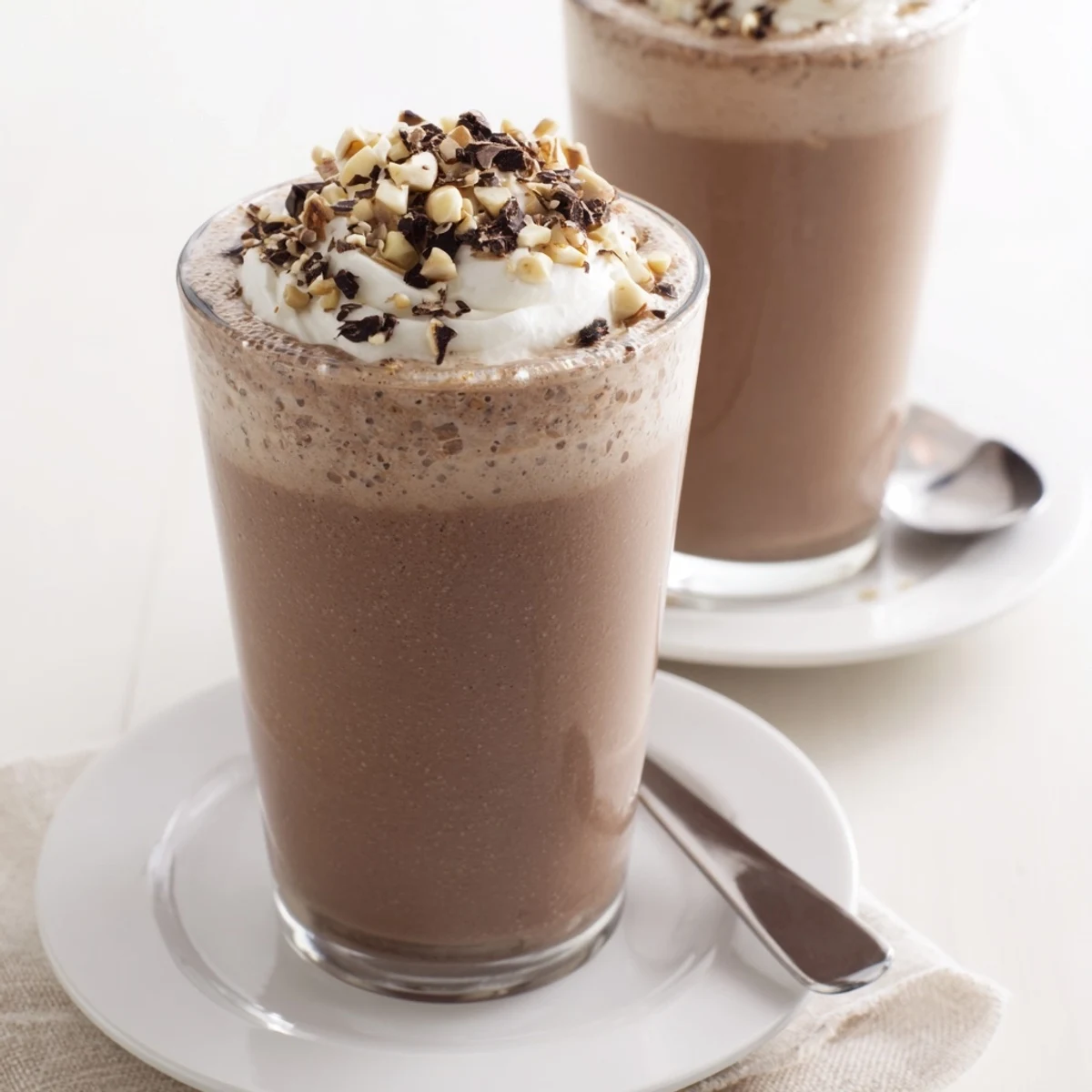 Decadent Chocolate Peanut Butter Smoothie poured in tall glass, sprinkled crushed peanuts