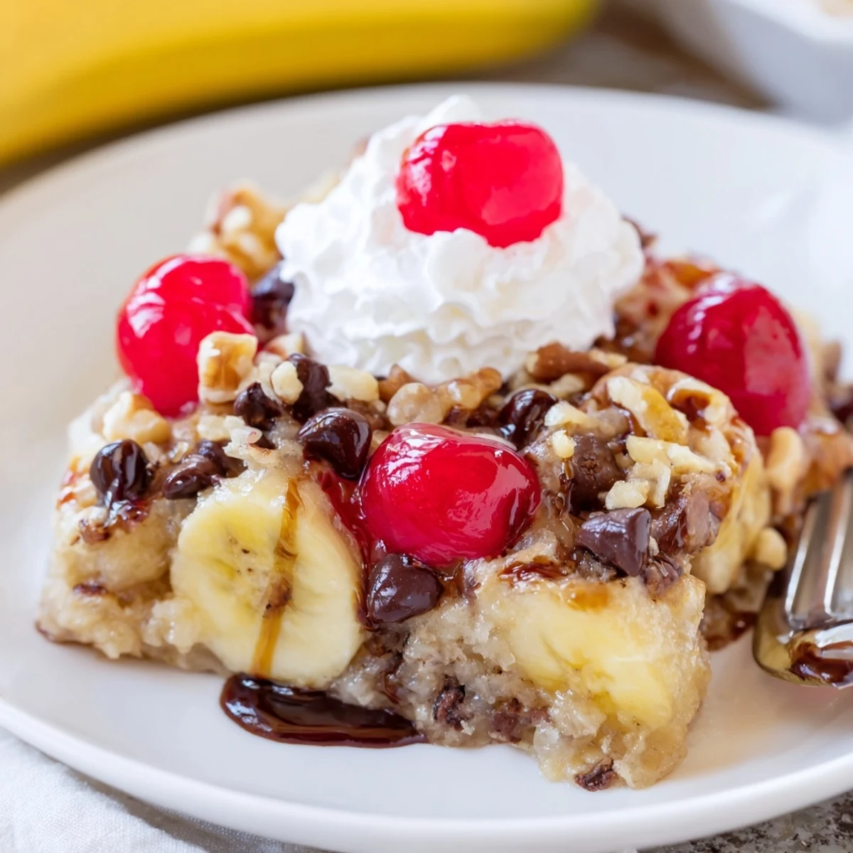 Slice of Banana Split Dump Cake with melted chocolate chips, nutty crunch