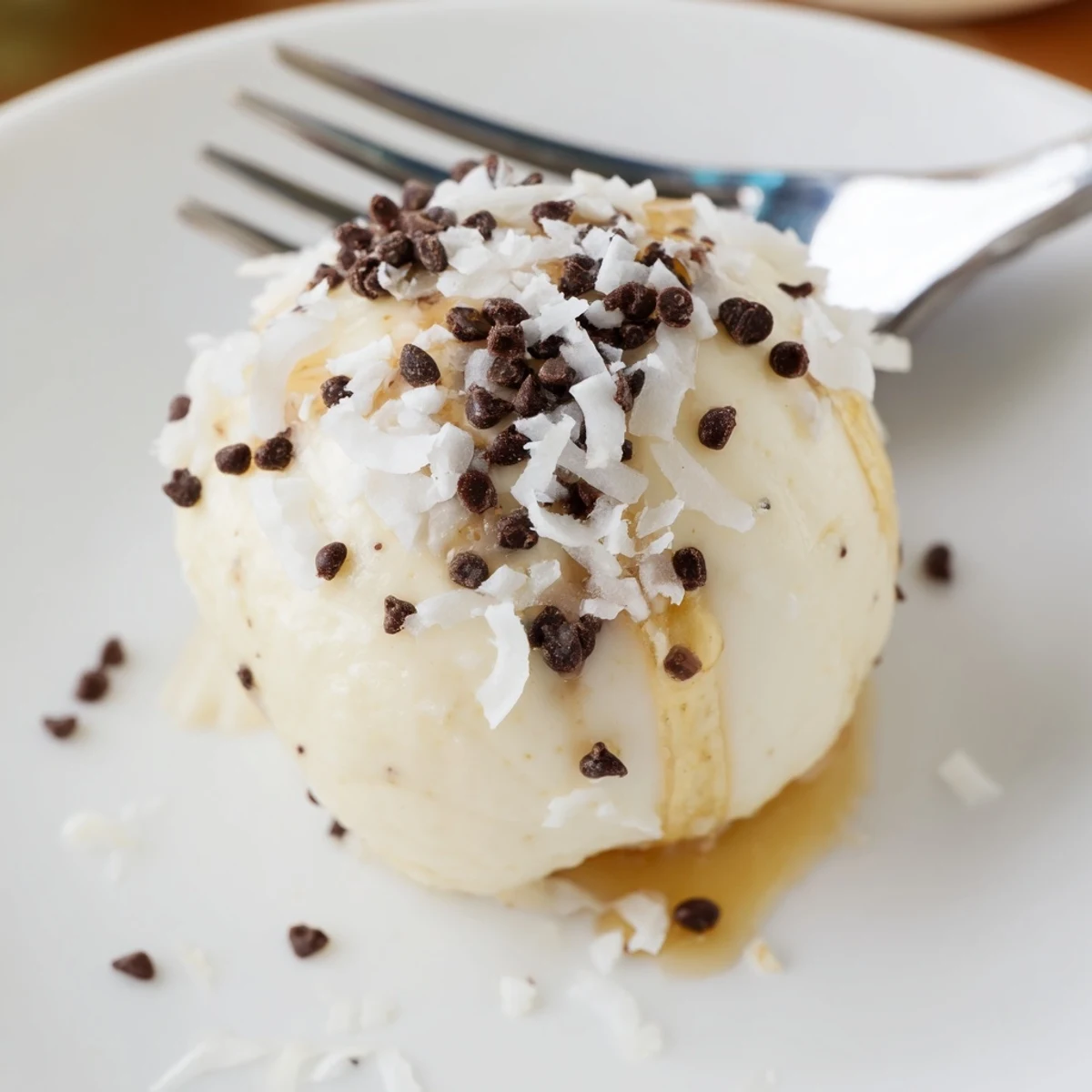 Frozen Banana Yogurt Bites chilled on parchment, creamy centers and coconut sprinkle
