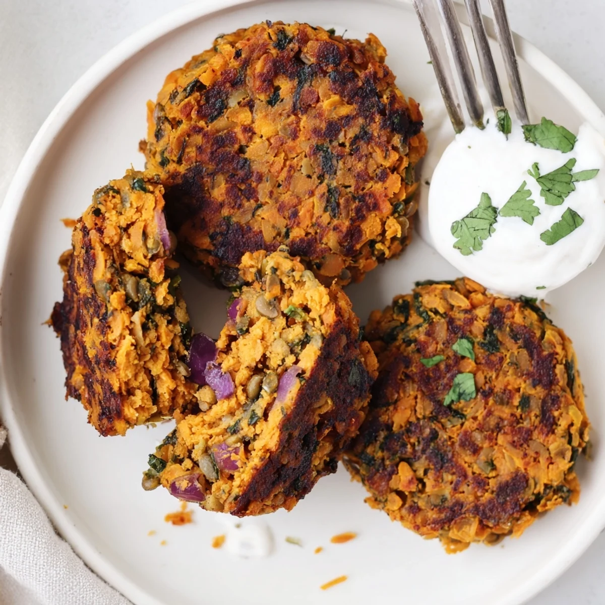 Golden, herb-speckled disks: Crispy Sweet Potato Lentil Patties with fragrant cilantro.