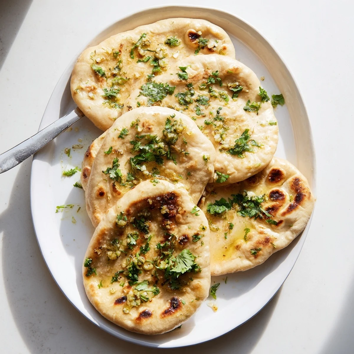 Fluffy Indian-style naan bread made with sourdough discard, perfect for scooping curries