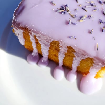 Silky lavender glaze pooling atop freshly baked scones with delicate purple streaks